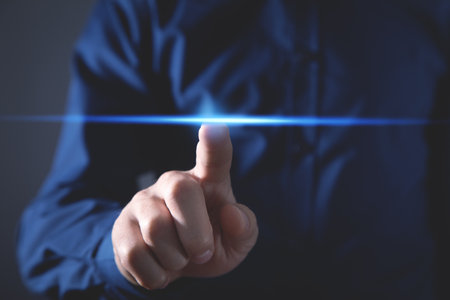 Man hand touch on a blue light.の写真素材