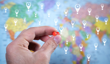 Male hand showing push pin. GPS concept on world map background. locationの写真素材