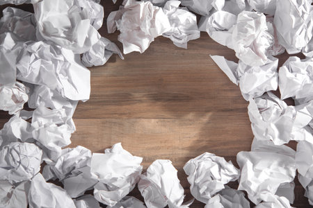 Crumpled paper balls on wooden background.の写真素材
