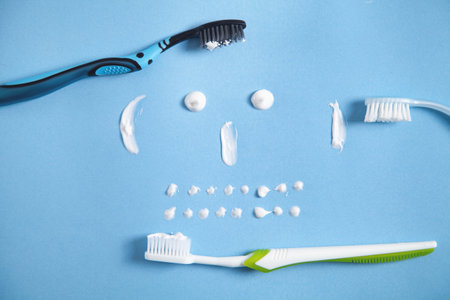 Toothbrush and toothpaste on the blue background. smiling faceの写真素材