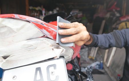 Preparation for painting a motorcycle. Hand in a sandpaperの写真素材