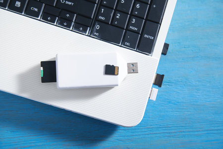 Flash drive and memory cards on the computer keyboard.の写真素材
