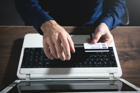 Businessman using laptop computer and holding credit card.の写真素材