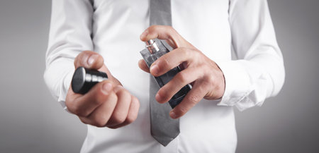 Man holding a bottle of perfume.