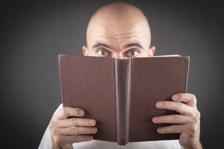 Man covered his face with a book.