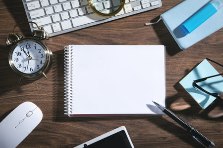 Empty notepad, computer keyboard and other business objects.の写真素材
