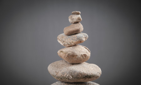 Balance stones on gray background.