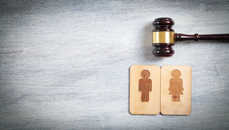 concept of divorce. Male and female wooden symbols and judge gavelの写真素材