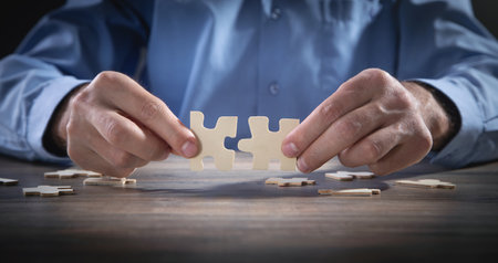 Male hands holding a jigsaw puzzle.