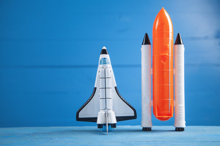 Toy space shuttle on blue background. rocket launchの写真素材