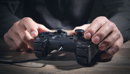 Caucasian man holding joystick. game. Addiction