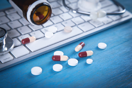 Pills and stethoscope on the computer keyboard.の写真素材