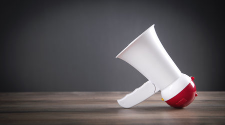 Megaphone on the wooden table. Attentionの写真素材