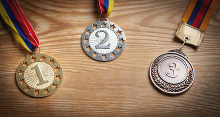 Medals awards for winner on wooden background.の写真素材