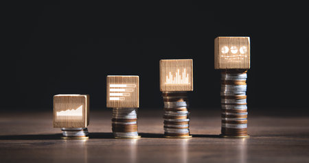 Coins with a growth graph on wooden cube. businessの写真素材