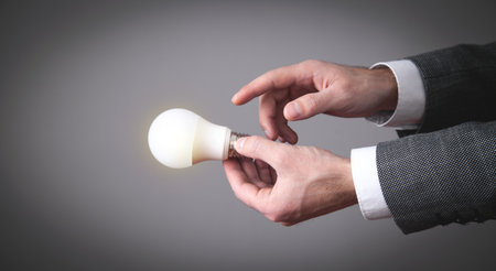 Male hand holding light bulb.の写真素材