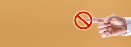 Male hand touching in a stop sign.の写真素材