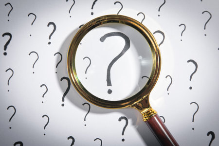 Magnifying glass and question mark on white background.