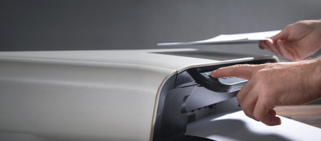 Man copying and scanning documents in office.の写真素材