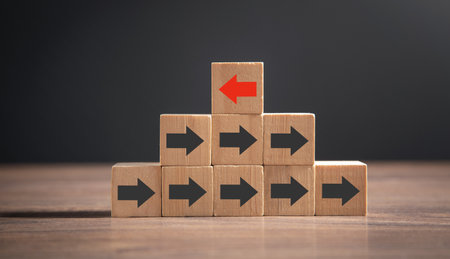 Red arrow opposite to black arrows direction.の写真素材