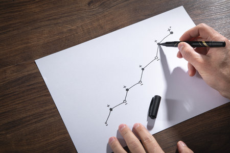 Male hand draws growth graph on paper.の写真素材