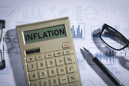 Inflation calculator with a pen and eyeglasses.