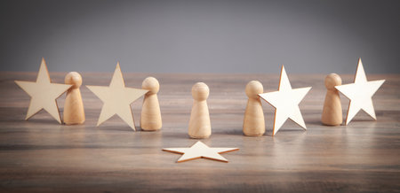 Wooden human figures with stars. Best customer evaluation and satisfaction