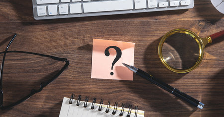 Question mark on sticky note with a business object.