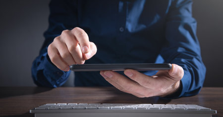 Caucasian businessman using smartphone at office.