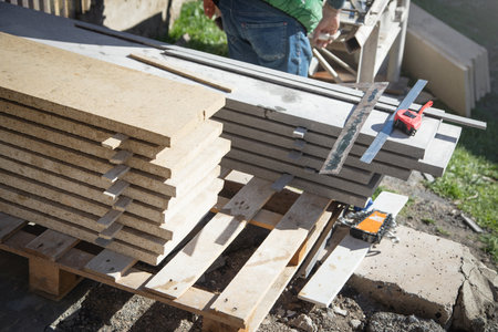 Tiles for house building with measuring tape.