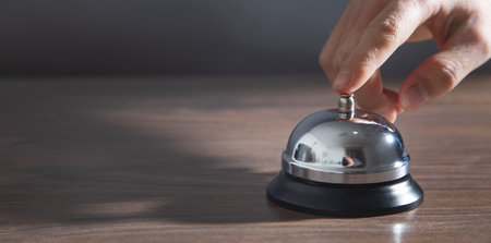 Male hand ringing in service bell.