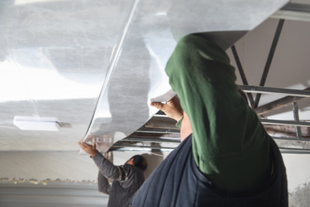 Construction worker assemble a suspended ceiling.
