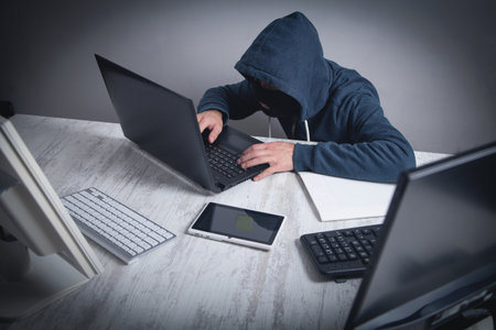 Hacker stealing information from the office computer. Hacking, Criminal