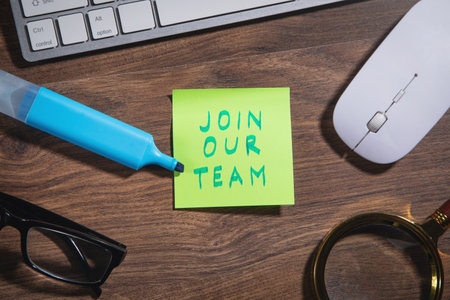 Join Our Team on sticky note with a marker, computer keyboard and other objects.の写真素材