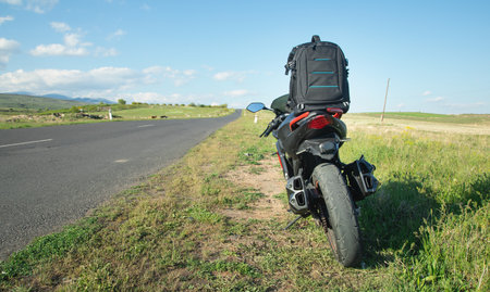 Backpack with a motorcycle outdoors. Ready for adventure and travel