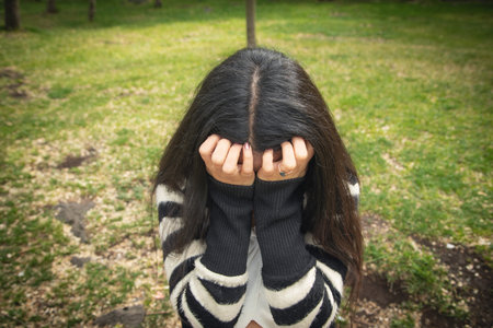 Young sad and depressed woman in the park.の写真素材
