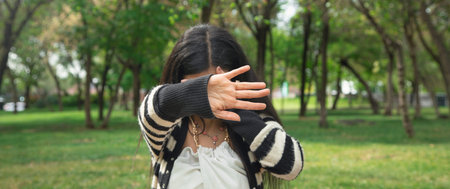 Woman covering her face and doing stop sign.の写真素材