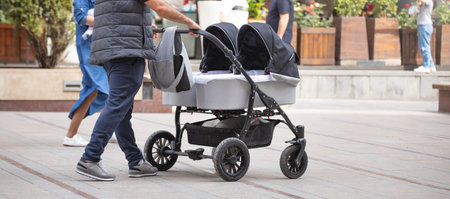 Father walking in city baby in stroller.