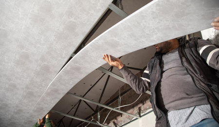 Construction worker assemble a suspended ceiling.