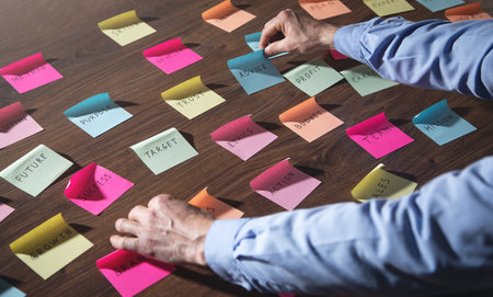 Businessman working with sticky notes in office.の写真素材