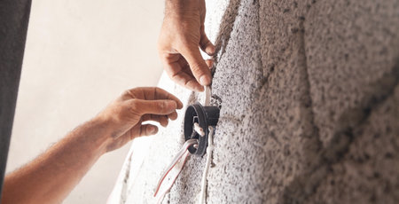 Electrician installation electrical cables at home.の写真素材