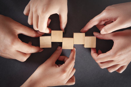 Hands of people showing wooden cubes.の写真素材