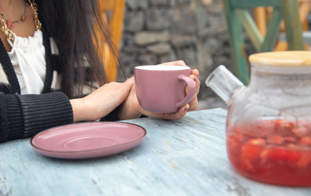 Woman drinking tasty tea at table in cafe.の写真素材
