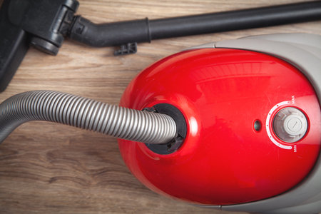 Vacuum cleaner on the wooden background.の写真素材