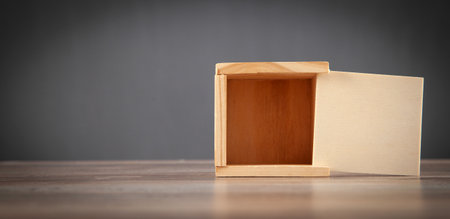 Small wooden box on the wooden table.