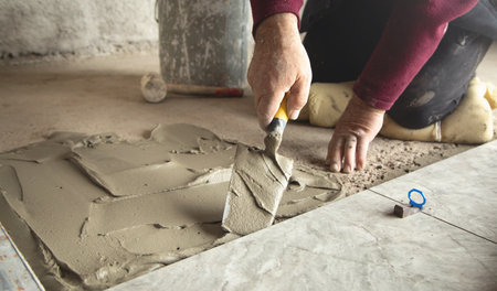 Laying floor tiles. Renovating the floor