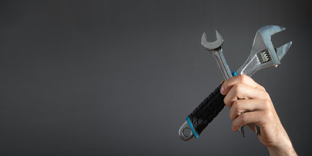 Male hand holding a wrench. Maintenanceの写真素材