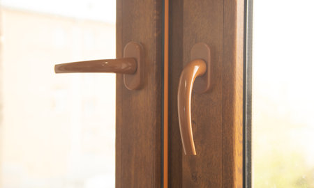 Brown closed window with handle.の写真素材