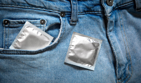 Condom in blue jeans pocket.の写真素材
