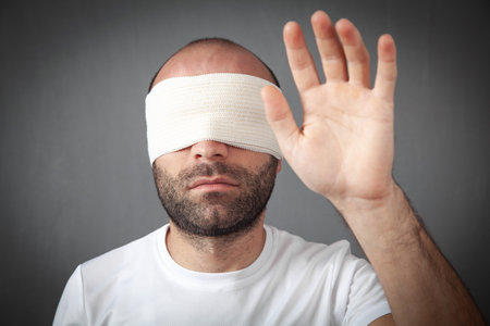 Caucasian young man with a blindfold.